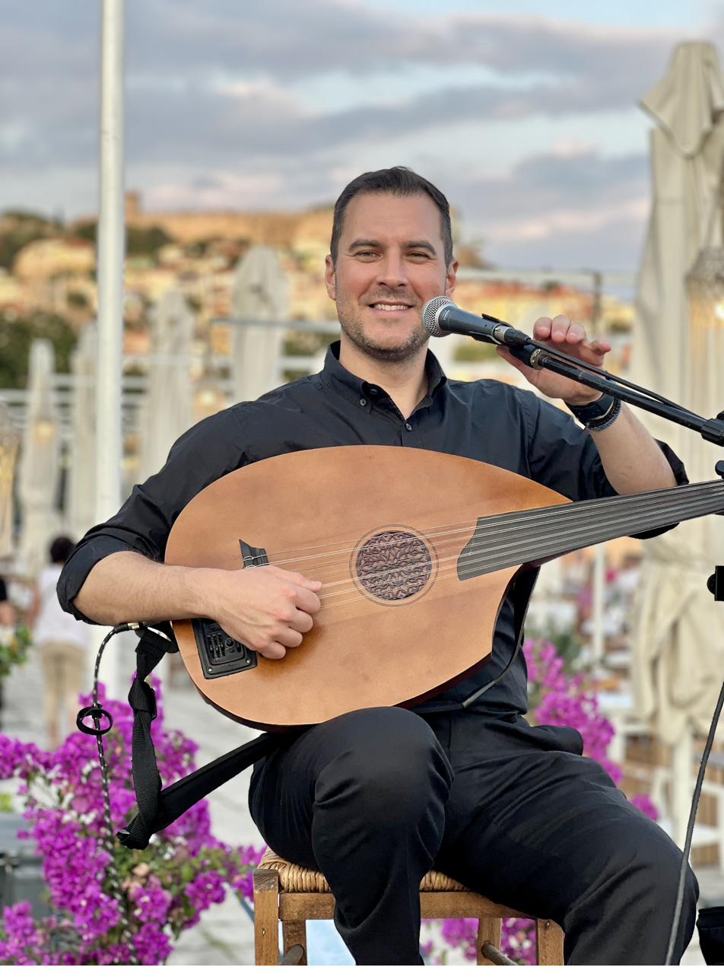 Performing on the oud at an open-air concert